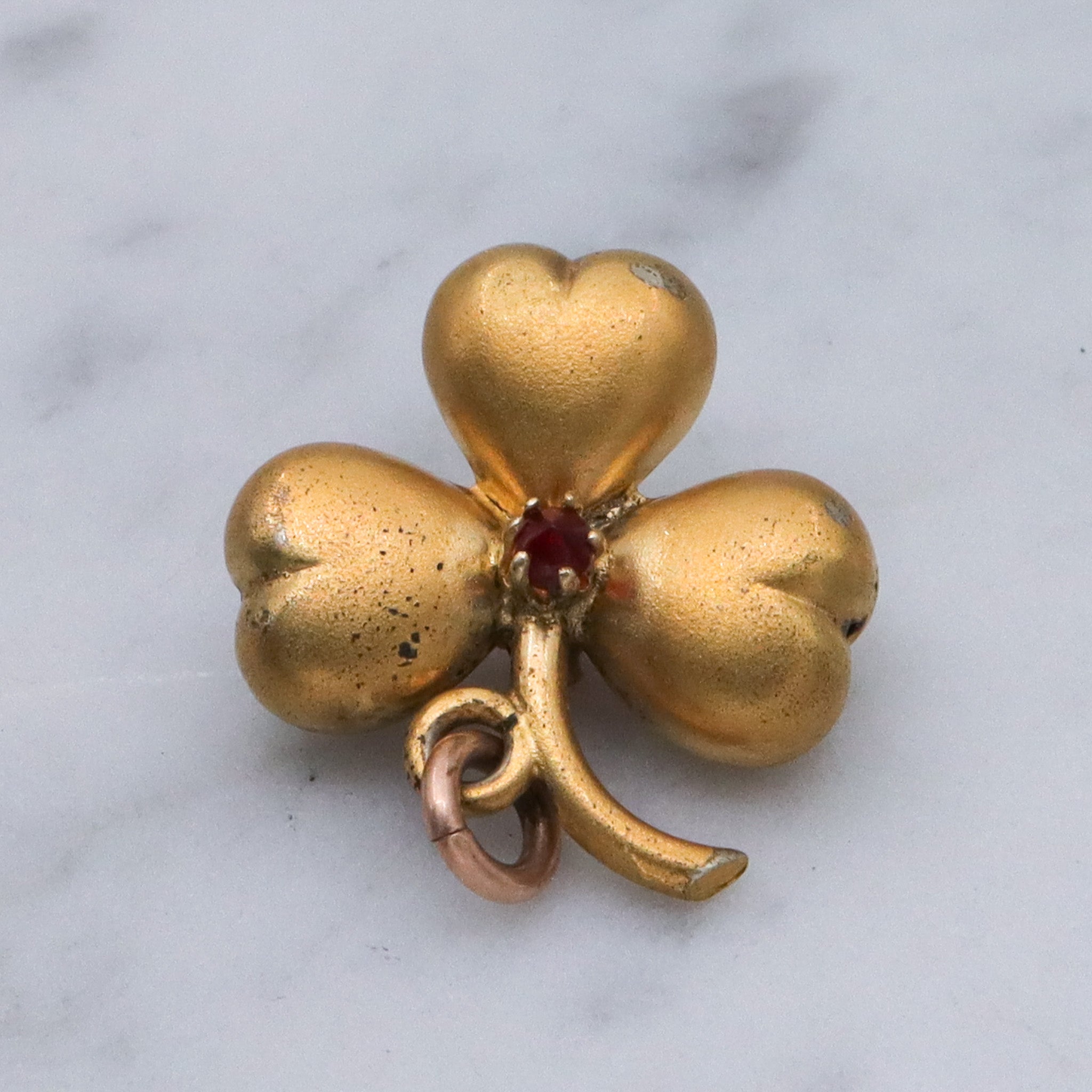 Antique Victorian gilt metal clover with faux garnet pendant